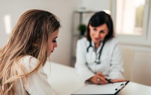 Doctor discussing paperwork with patient